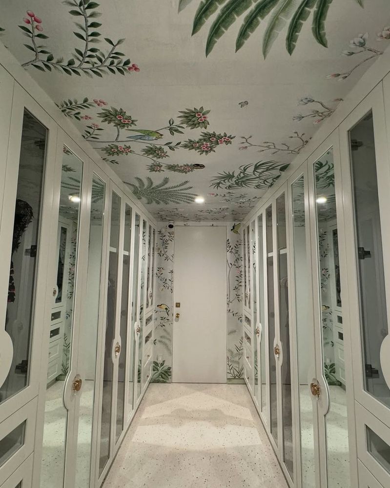 Mirrored dressing room with chinoiserie floral wallpaper carried up onto the ceiling